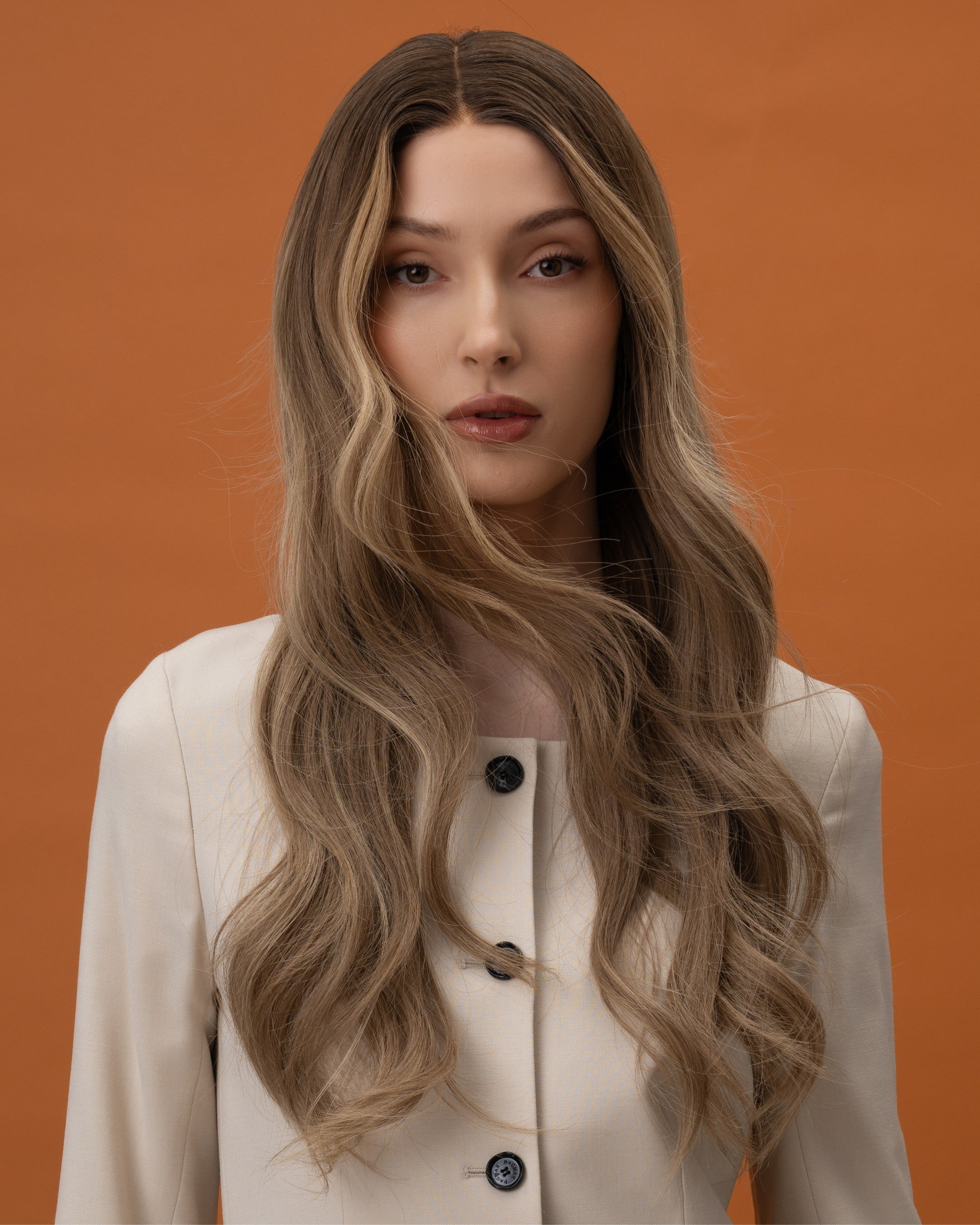 Noble Nightshade Wig 50 cm dark blonde root blending into lighter lengths with soft money-piece highlights, hand-tied 100% Remy human hair on HD lace, shown on model for a modern and luxurious look.