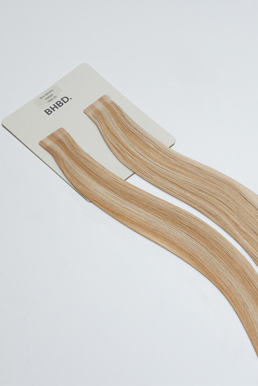 Tape Extensions 10NB/12N – pre-taped Remy human hair extensions in light beige blonde blended with natural blonde; seamless, soft and tangle-free; comes in 35cm, 50cm, and 60cm. 100% Remy hair, gentle extensions