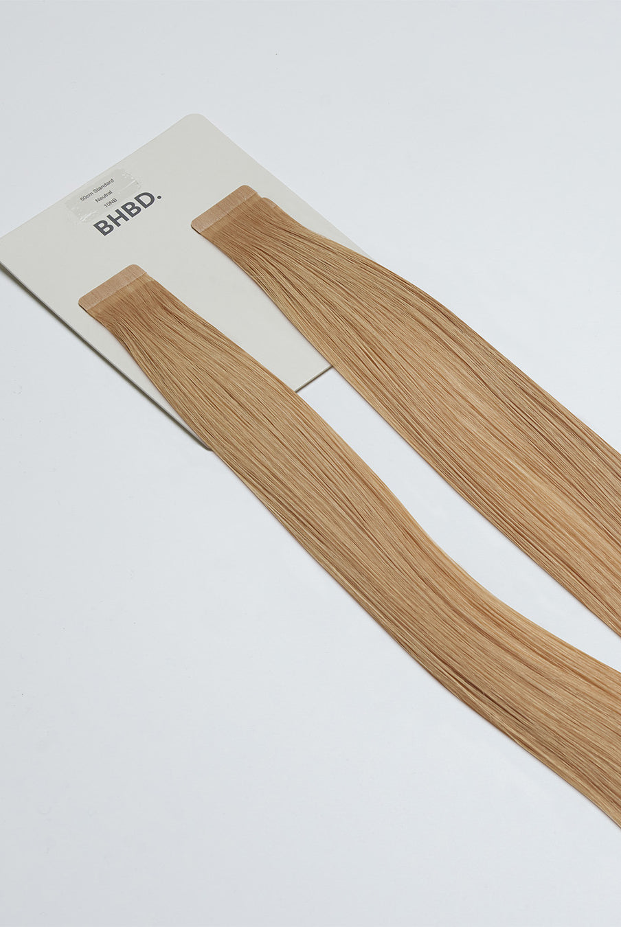 Tape Extensions 10NB – pre-taped Remy human hair extensions in light natural beige blonde shade; seamless, soft and tangle-free; comes in 35cm, 50cm, and 60cm. 100% Remy hair, gentle extensions.