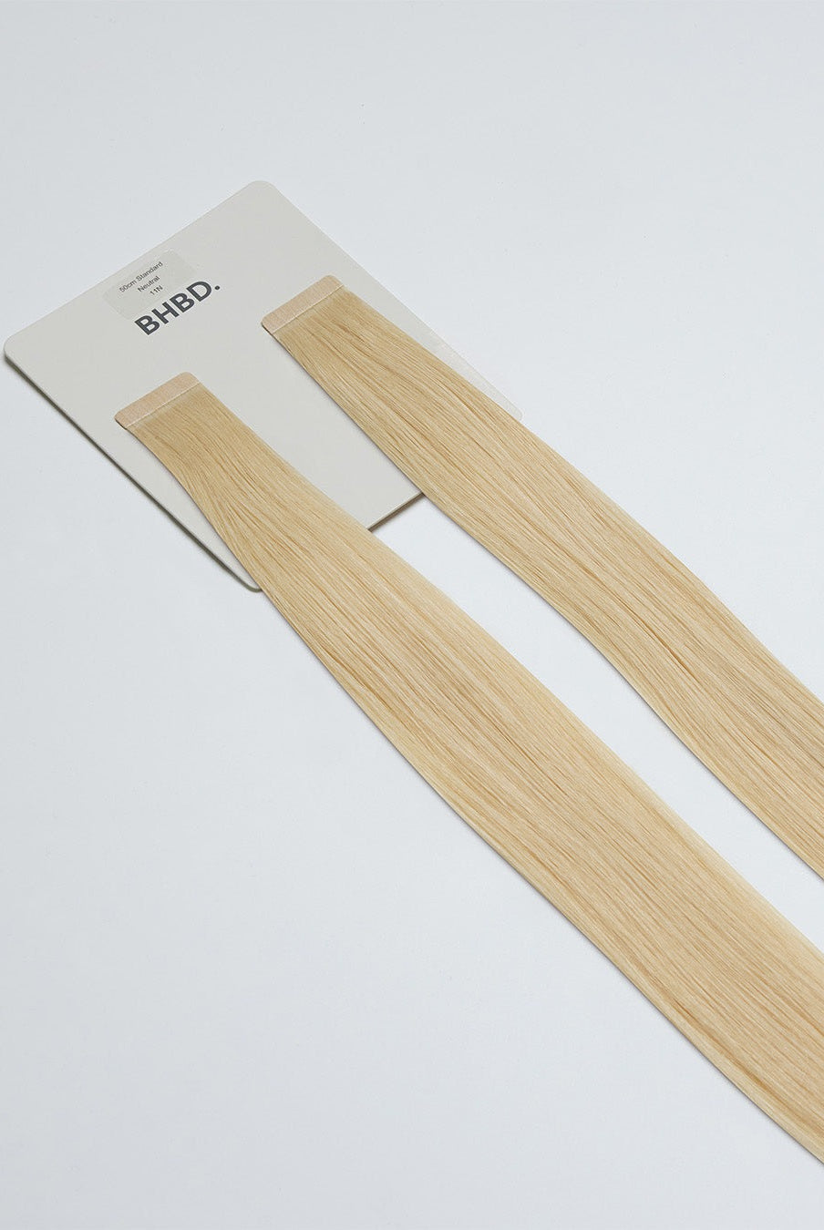 Tape Extensions 11N – pre-taped Remy human hair extensions in a light natural blonde shade; seamless, soft and tangle-free; comes in 35cm, 50cm, and 60cm. 100% Remy hair, gentle extensions.