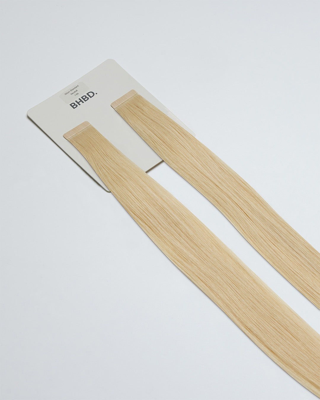 Tape Extensions 11N – pre-taped Remy human hair extensions in a light natural blonde shade; seamless, soft and tangle-free; comes in 35cm, 50cm, and 60cm. 100% Remy hair, gentle extensions.