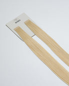Tape Extensions 11N – pre-taped Remy human hair extensions in a light natural blonde shade; seamless, soft and tangle-free; comes in 35cm, 50cm, and 60cm. 100% Remy hair, gentle extensions.