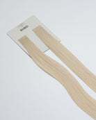 Tape Extensions 12N – pre-taped Remy human hair extensions in light natural blonde shade; seamless, soft and tangle-free; comes in 35cm, 50cm, and 60cm. 100% Remy hair, gentle extensions.