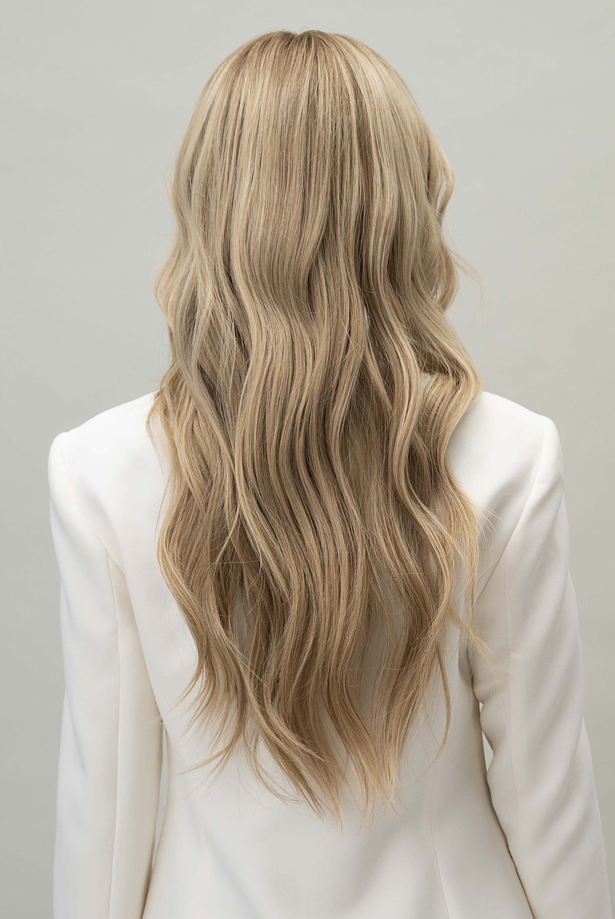 Scarlet Wig 50 cm Remy human hair wig with darker blonde roots blending into natural blonde lengths with lowlights, shown from back.