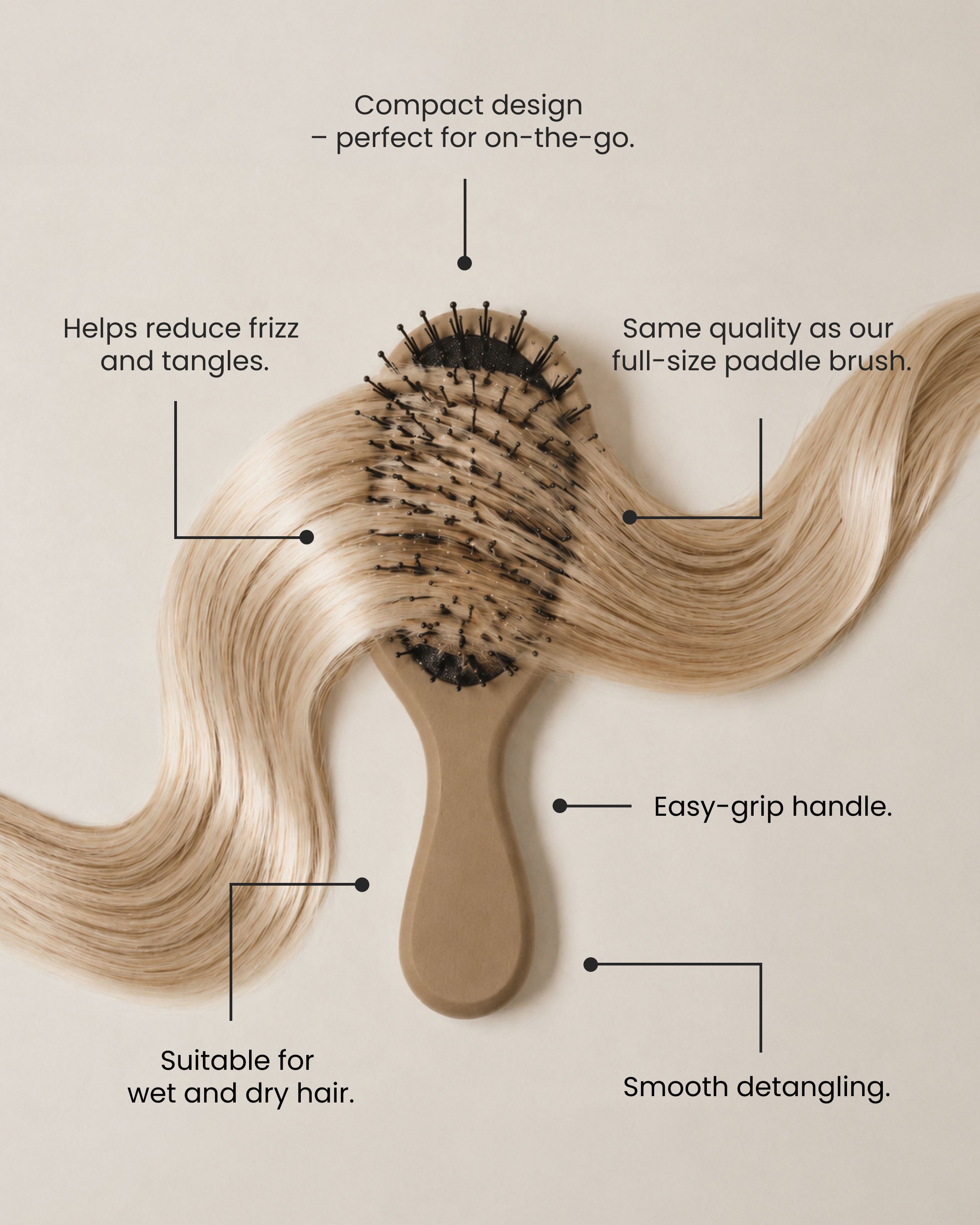 Compact mini paddle brush for detangling hair, reducing frizz and suitable for on-the-go use.