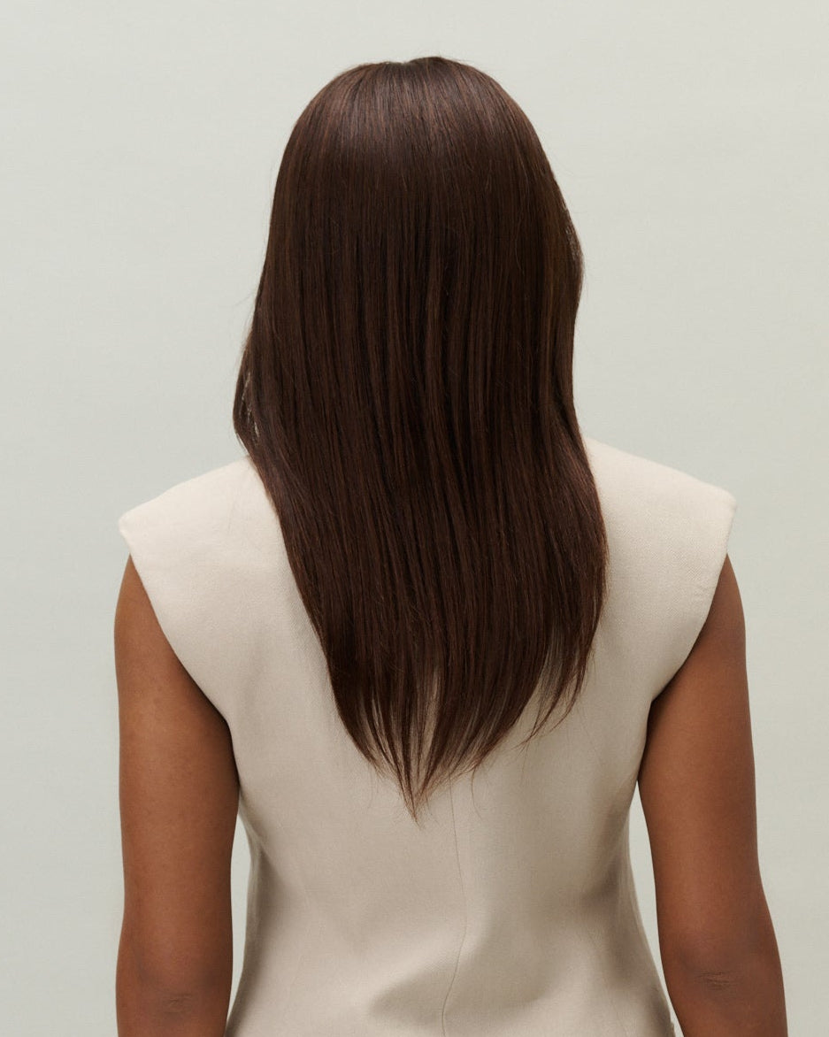 Peony Wig 30 cm dark brown Remy human hair wig with smooth layered lengths and natural movement, shown from the back on model.