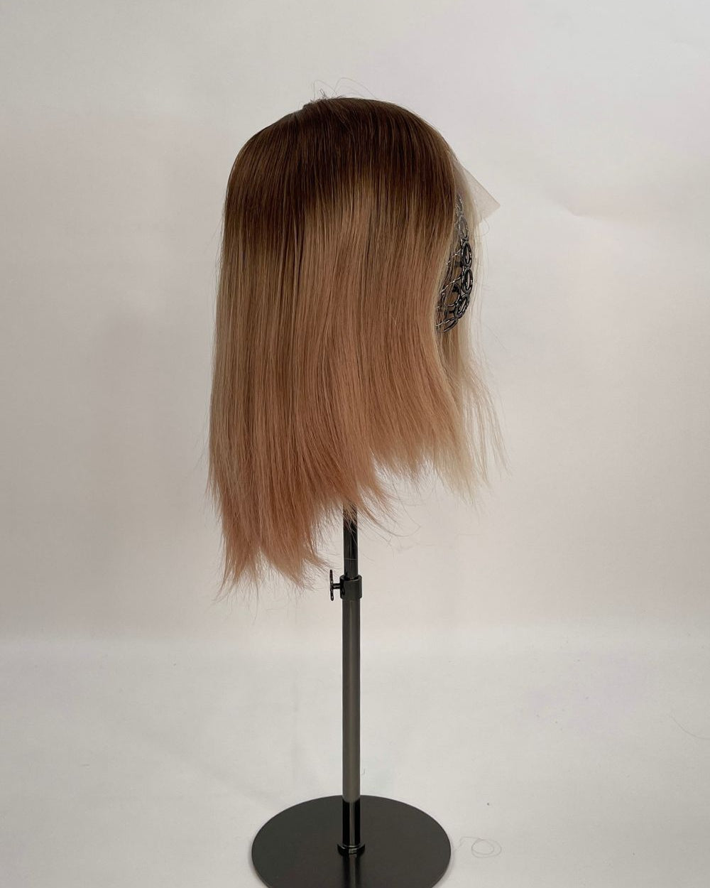 Sophia Wig – medium brown with subtle highlights, 30cm full-lace wig; 100% Remy hair with transparent Swiss lace; shown on wid stand from the side.