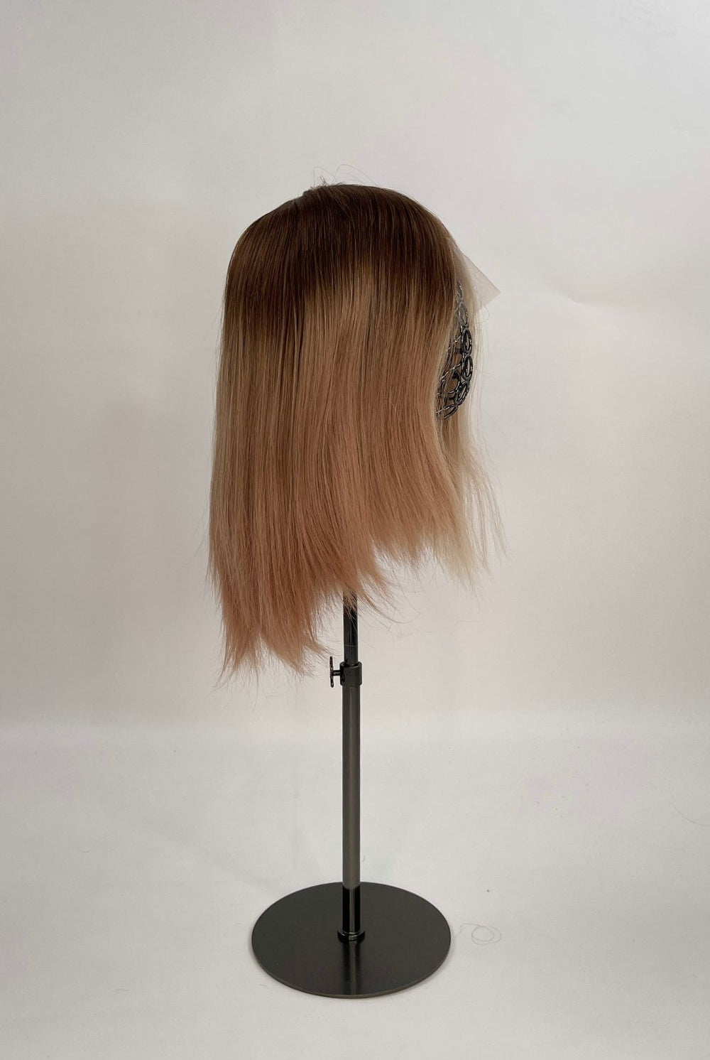 Sophia Wig – medium brown with subtle highlights, 30cm full-lace wig; 100% Remy hair with transparent Swiss lace; shown on wid stand from the side.