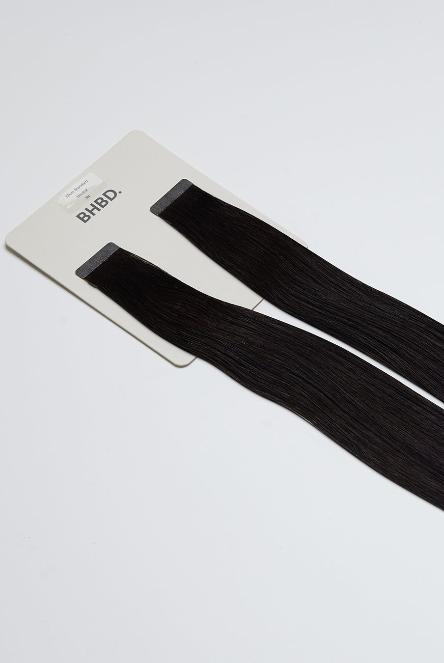Tape Extensions 3N – pre-taped Remy human hair extensions in dark natural brown shade; seamless, soft and tangle-free; comes in 35cm, 50cm, and 60cm. 100% Remy hair, gentle extensions.