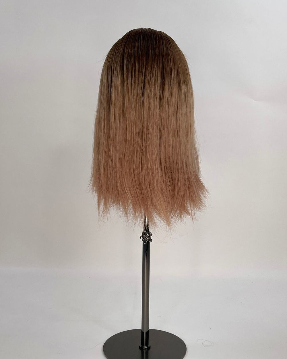 Sophia Wig – medium brown with subtle highlights, 30cm full-lace wig; 100% Remy hair with transparent Swiss lace; shown on wid stand from the back.