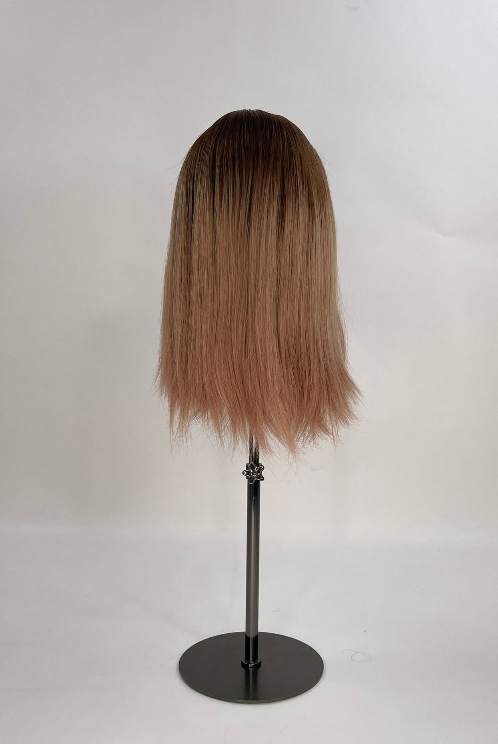 Sophia Wig – medium brown with subtle highlights, 30cm full-lace wig; 100% Remy hair with transparent Swiss lace; shown on wid stand from the back.