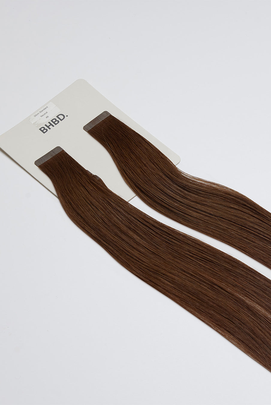 Tape Extensions 4B – pre-taped Remy human hair extensions in dark brown shade; seamless, soft and tangle-free; comes in 35cm, 50cm, and 60cm. 100% Remy hair,