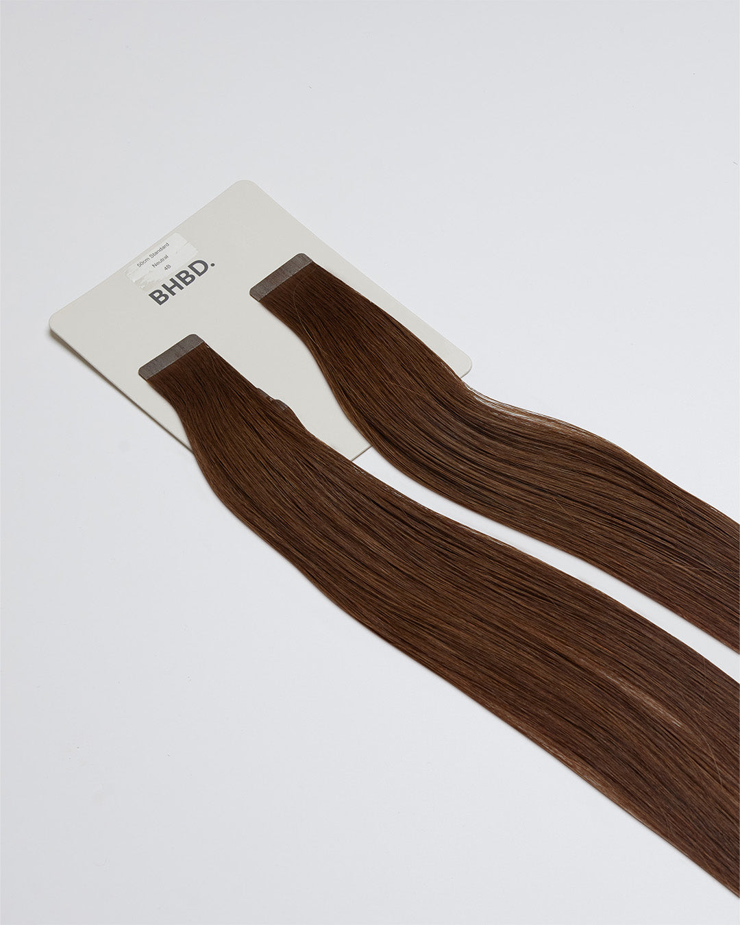 Tape Extensions 4B – pre-taped Remy human hair extensions in dark brown shade; seamless, soft and tangle-free; comes in 35cm, 50cm, and 60cm. 100% Remy hair,