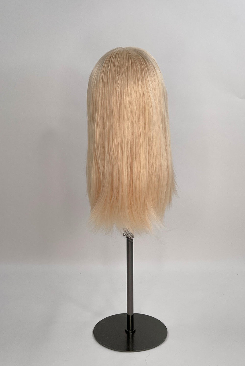 Bianca Wig – light blonde, 30cm full-lace wig; 100% Remy hair with transparent Swiss lace and natural density on a wig stand from the back.