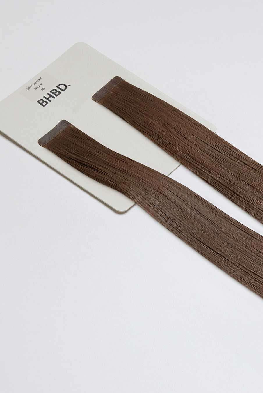 Tape Extensions 5B – pre-taped Remy human hair extensions in medium brown shade; seamless, soft and tangle-free; comes in 35cm, 50cm, and 60cm. 100% Remy hair, gentle extensions.