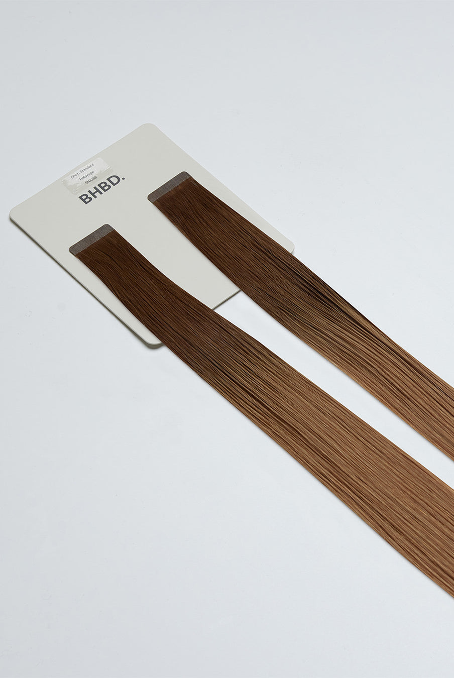 Tape Extensions 5NA/8B – pre-taped Remy human hair extensions in natural ash brown and medium blonde mix; seamless, soft and tangle-free; comes in 35cm, 50cm, and 60cm. 100% Remy hair, gentle extensions.