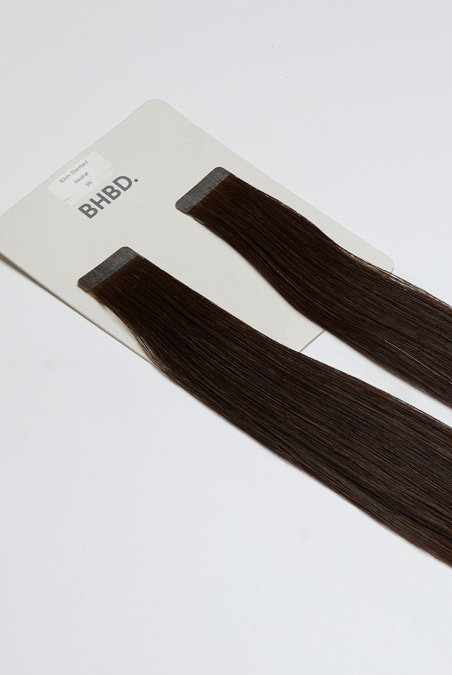 Tape Extensions 5N – pre-taped Remy human hair extensions in medium natural brown shade; seamless, soft and tangle-free; comes in 35cm, 50cm, and 60cm. 100% Remy hair, gentle extensions.