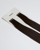 Tape Extensions 5N – pre-taped Remy human hair extensions in medium natural brown shade; seamless, soft and tangle-free; comes in 35cm, 50cm, and 60cm. 100% Remy hair, gentle extensions.