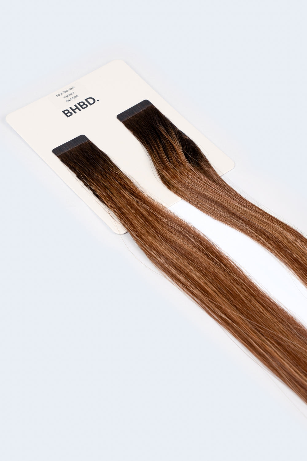 BHBD Tape Extensions 5N/5G/8G – pre-taped Remy human hair extensions in blended brown and golden blonde shades; seamless, soft and tangle-free; comes in 35cm, 50cm, and 60cm. 100% Remy hair, gentle extensions.