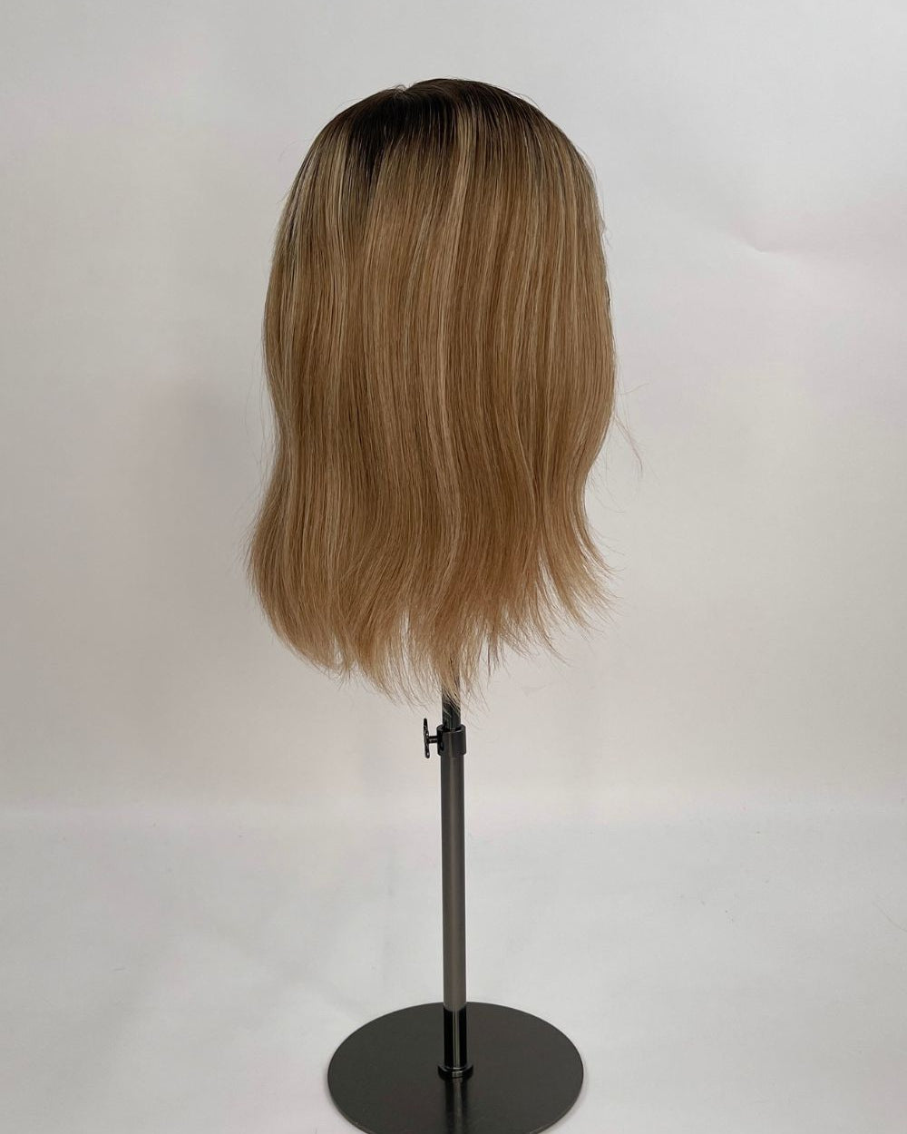 Serena Wig – dark brown root lighter brown lengths, 30cm full-lace wig; 100% Remy hair with transparent Swiss lace; shown on wig stand from side.