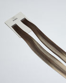 Tape Extensions 6A/12N – pre-taped Remy human hair extensions in medium ash brown blended with light natural blonde; seamless, soft and tangle-free; comes in 35cm, 50cm, and 60cm. 100% Remy hair, gentle extensions.
