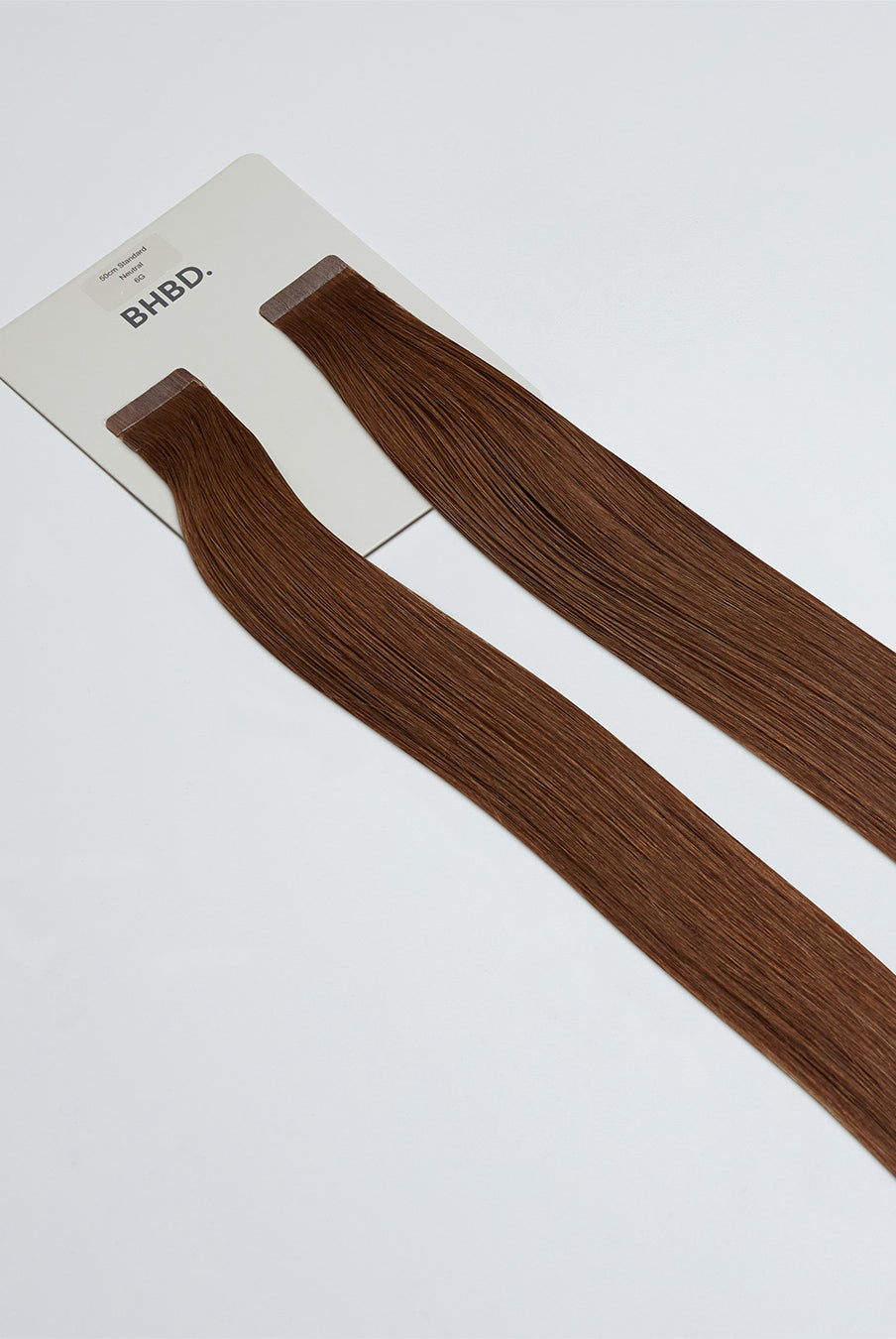 Tape Extensions 6G – pre-taped Remy human hair extensions in golden medium brown shade; seamless, soft and tangle-free; comes in 35cm, 50cm, and 60cm. 100% Remy hair, gentle extensions.