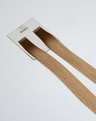 Tape Extensions 6N/10NB – pre-taped Remy human hair extensions in natural brown blended with light beige blonde; seamless, soft and tangle-free; comes in 35cm, 50cm, and 60cm. 100% Remy hair, gentle extensions.