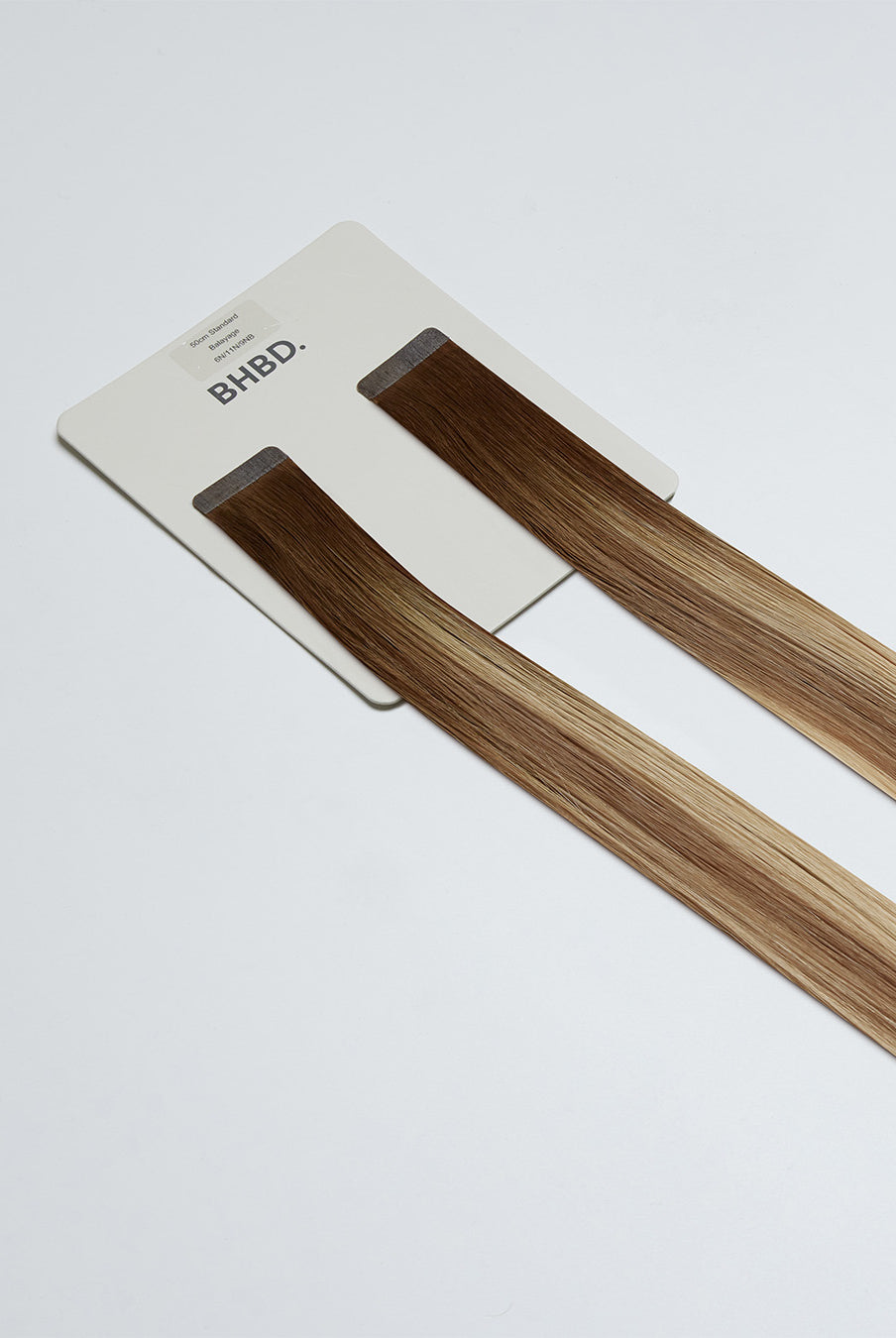 Tape Extensions 6N/11N/9NB – pre-taped Remy human hair extensions in medium natural brown, medium blonde, and natural beige blonde mix; seamless, soft and tangle-free; comes in 35cm, 50cm, and 60cm. 100% Remy hair, gentle extensions.