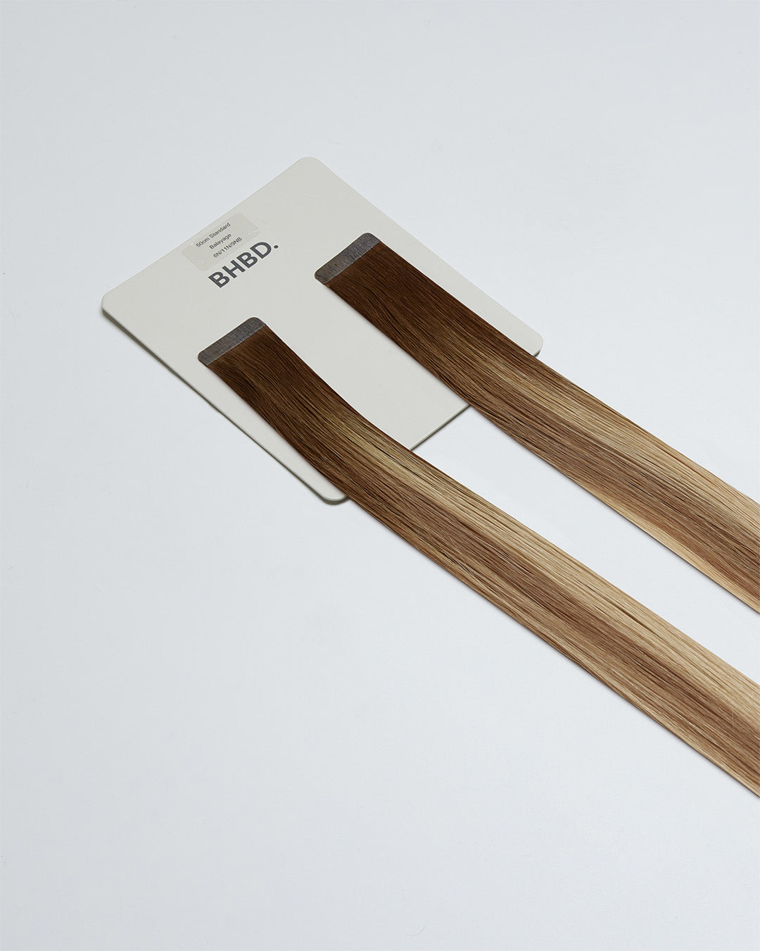 Tape Extensions 6N/11N/9NB – pre-taped Remy human hair extensions in medium natural brown, medium blonde, and natural beige blonde mix; seamless, soft and tangle-free; comes in 35cm, 50cm, and 60cm. 100% Remy hair, gentle extensions.