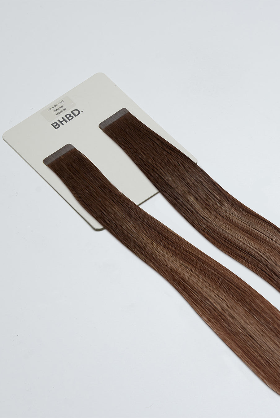 Tape Extensions 6N/6G/9B – pre-taped Remy human hair extensions in natural brown, golden brown, and light beige blonde blend; seamless, soft and tangle-free; comes in 35cm, 50cm, and 60cm. 100% Remy hair, gentle extensions.