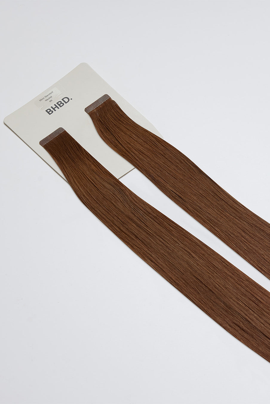 Tape Extensions 6N – pre-taped Remy human hair extensions in medium natural brown shade; seamless, soft and tangle-free; comes in 35cm, 50cm, and 60cm. 100% Remy hair, gentle extensions.