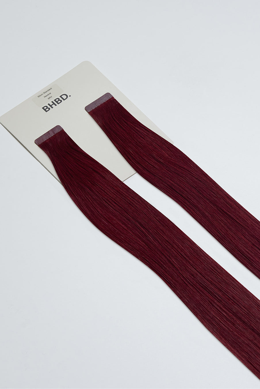 Tape Extensions 6RV – pre-taped Remy human hair extensions in deep red-violet shade; seamless, soft and tangle-free; comes in 35cm, 50cm, and 60cm. 100% Remy hair, gentle extensions.