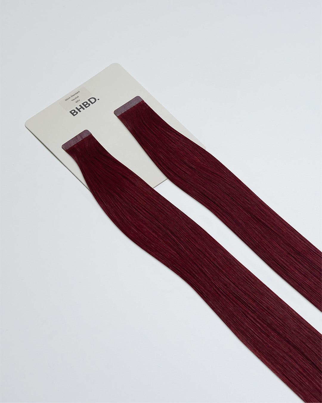 Tape Extensions 6RV – pre-taped Remy human hair extensions in deep red-violet shade; seamless, soft and tangle-free; comes in 35cm, 50cm, and 60cm. 100% Remy hair, gentle extensions.