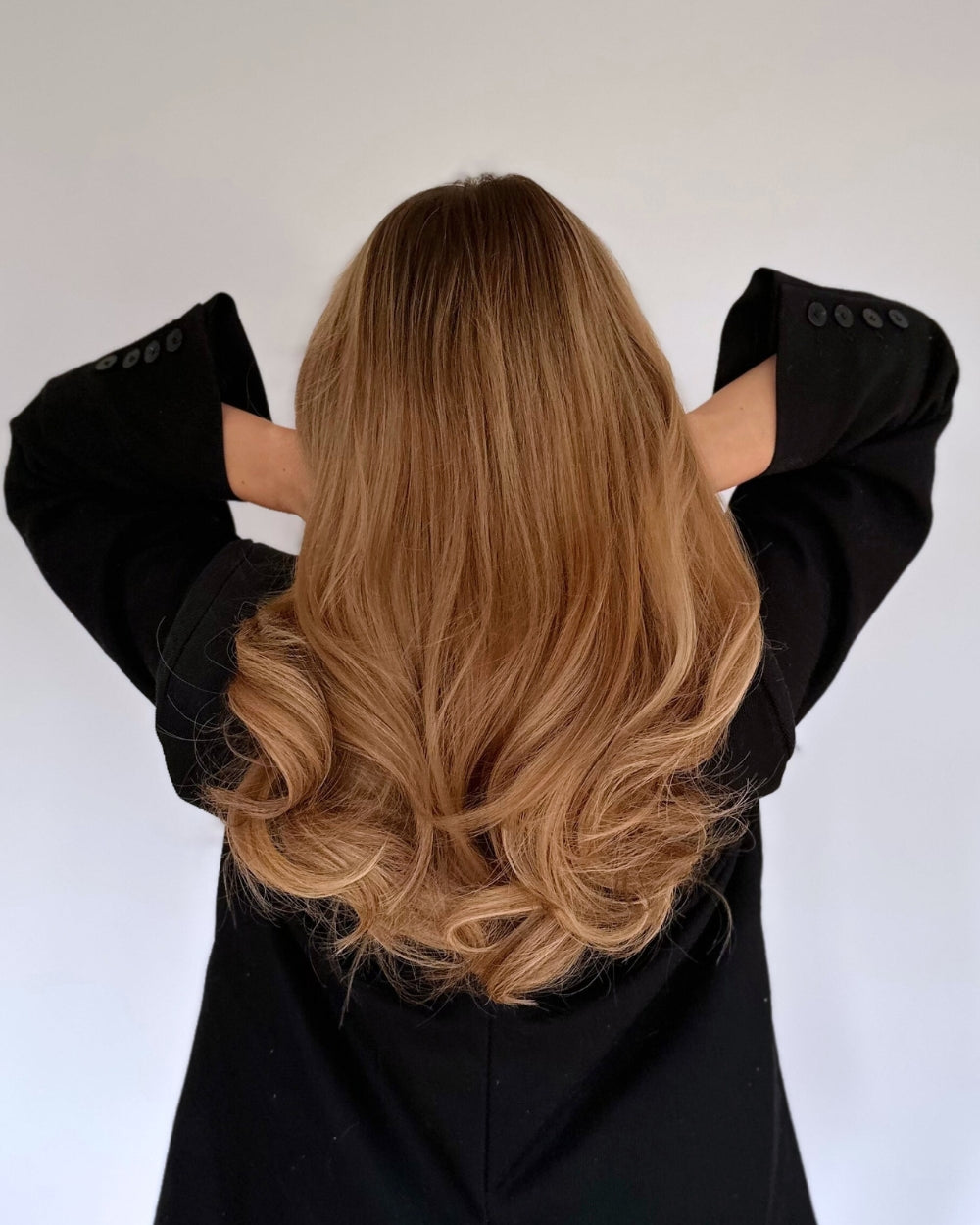 Model showing voluminous curls styled with BHBD Heatless Curls silk curler. No heat, gentle overnight styling.
