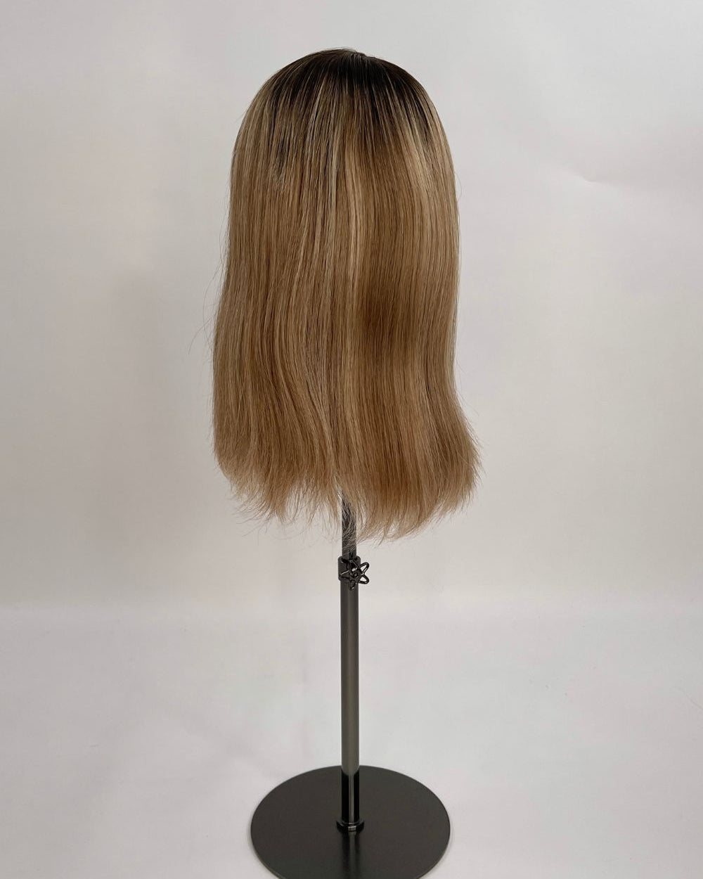 Serena Wig – dark brown root lighter brown lengths, 30cm full-lace wig; 100% Remy hair with transparent Swiss lace; shown on wig stand from back.