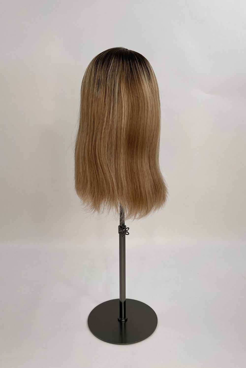 Serena Wig – dark brown root lighter brown lengths, 30cm full-lace wig; 100% Remy hair with transparent Swiss lace; shown on wig stand from back.