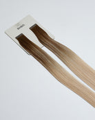 Tape Extensions 7N/11A/10G – pre-taped Remy human hair extensions in medium natural blonde, light ash blonde, and golden blonde blend; seamless, soft and tangle-free; comes in 35cm, 50cm, and 60cm. 100% Remy hair, gentle extensions.