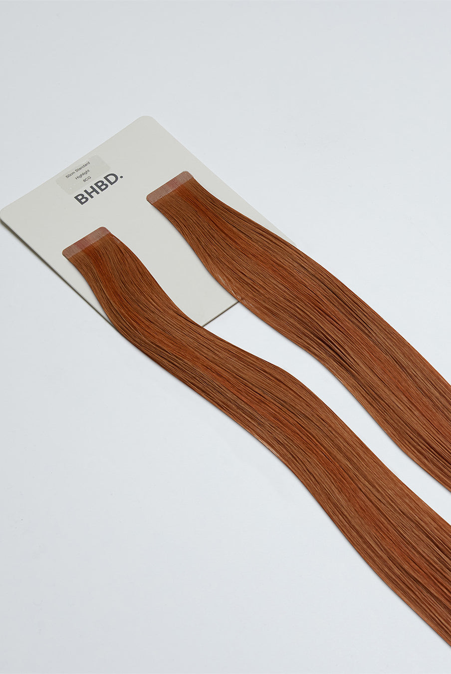 Tape Extensions 8CG – pre-taped Remy human hair extensions in copper golden blonde shade; seamless, soft and tangle-free; comes in 35cm, 50cm, and 60cm. 100% Remy hair, gentle extensions.