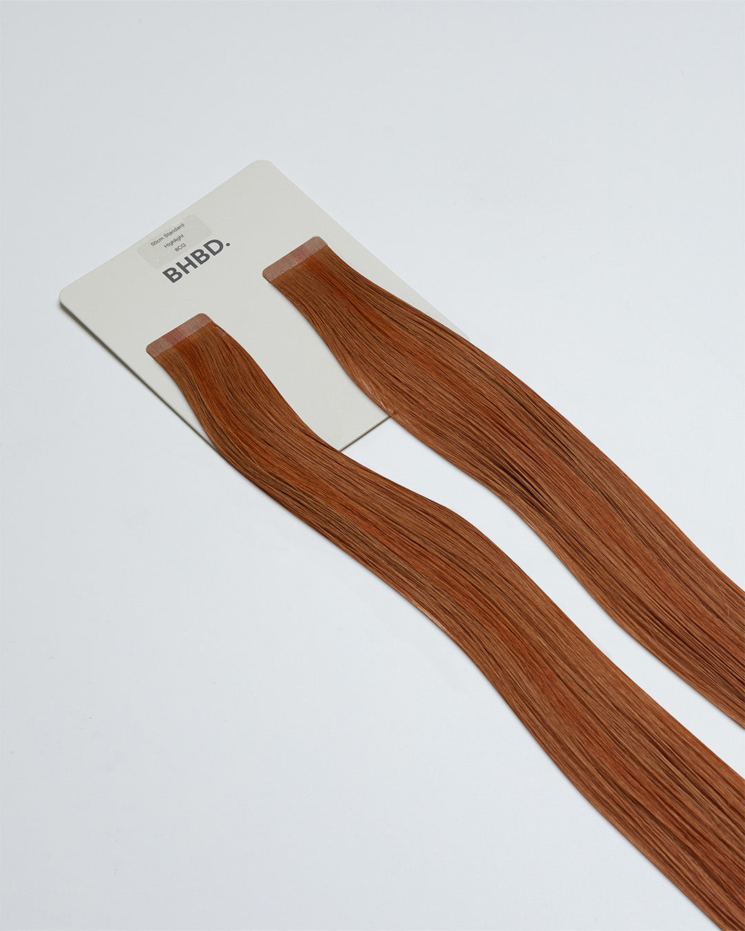 Tape Extensions 8CG – pre-taped Remy human hair extensions in copper golden blonde shade; seamless, soft and tangle-free; comes in 35cm, 50cm, and 60cm. 100% Remy hair, gentle extensions.