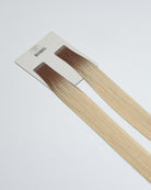 Tape Extensions 8P/11N – pre-taped Remy human hair extensions in pearl blonde blended with medium natural blonde; seamless, soft and tangle-free; comes in 35cm, 50cm, and 60cm. 100% Remy hair, gentle extensions.