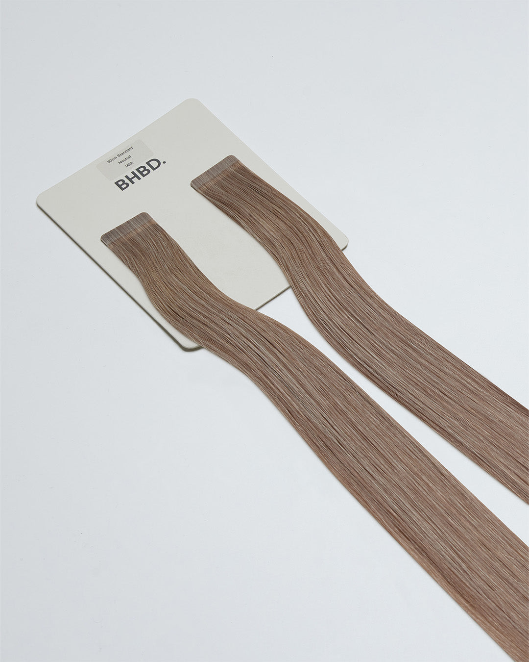 Tape Extensions 9BA – pre-taped Remy human hair extensions in light ash blonde shade; seamless, soft and tangle-free; comes in 35cm, 50cm, and 60cm. 100% Remy hair, gentle extensions.