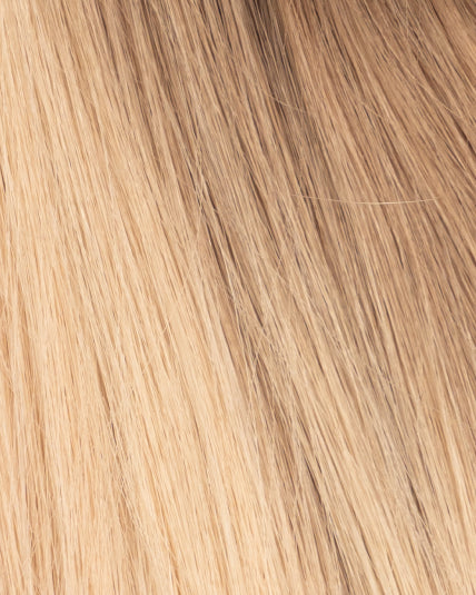Close-up of hair topper in balayage blond shade with soft root blend into light blond lengths.