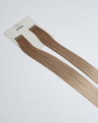 Tape Extensions 9B/11BA – pre-taped Remy human hair extensions in light beige blonde and ash blonde mix; seamless, soft and tangle-free; comes in 35cm, 50cm, and 60cm. 100% Remy hair, gentle extensions.