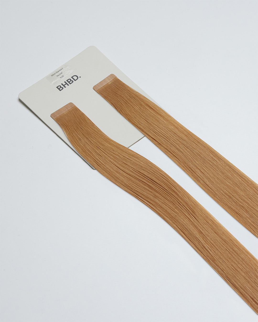 Tape Extensions 9GB – pre-taped Remy human hair extensions in golden beige blonde shade; seamless, soft and tangle-free; comes in 35cm, 50cm, and 60cm. 100% Remy hair, gentle extensions.