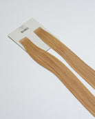 Tape Extensions 9NB – pre-taped Remy human hair extensions in natural beige blonde shade; seamless, soft and tangle-free; comes in 35cm, 50cm, and 60cm. 100% Remy hair, gentle extensions.