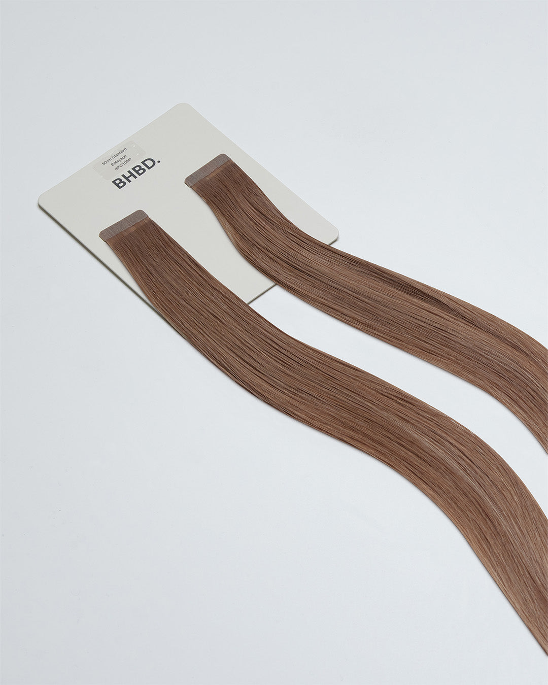 Tape Extensions 8PV/10BP – pre-taped Remy human hair extensions in pearl violet blonde and beige pearl tones; seamless, soft and tangle-free; comes in 35cm, 50cm, and 60cm. 100% Remy hair, gentle extensions.