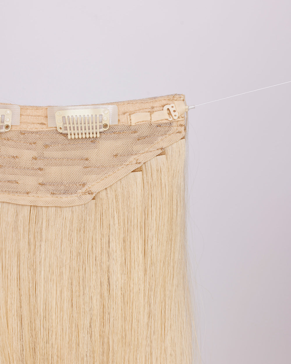 Close-up of headband clip: hook & fishing line for adjustability.