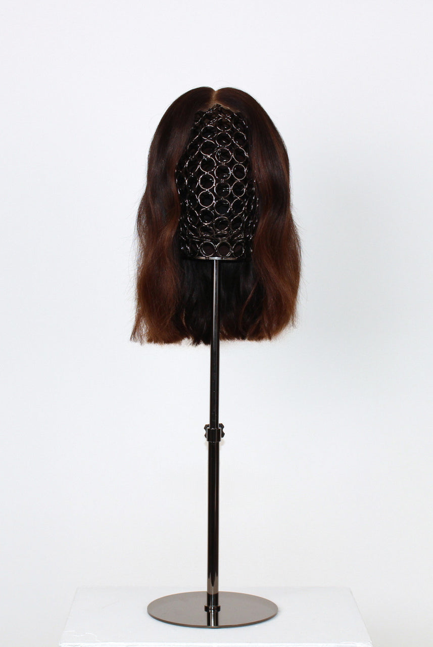 Celosia Wig 30 cm human-hair wig with dark to light brown blend and HD-lace front for realistic scalp effect, displayed on stand. front view