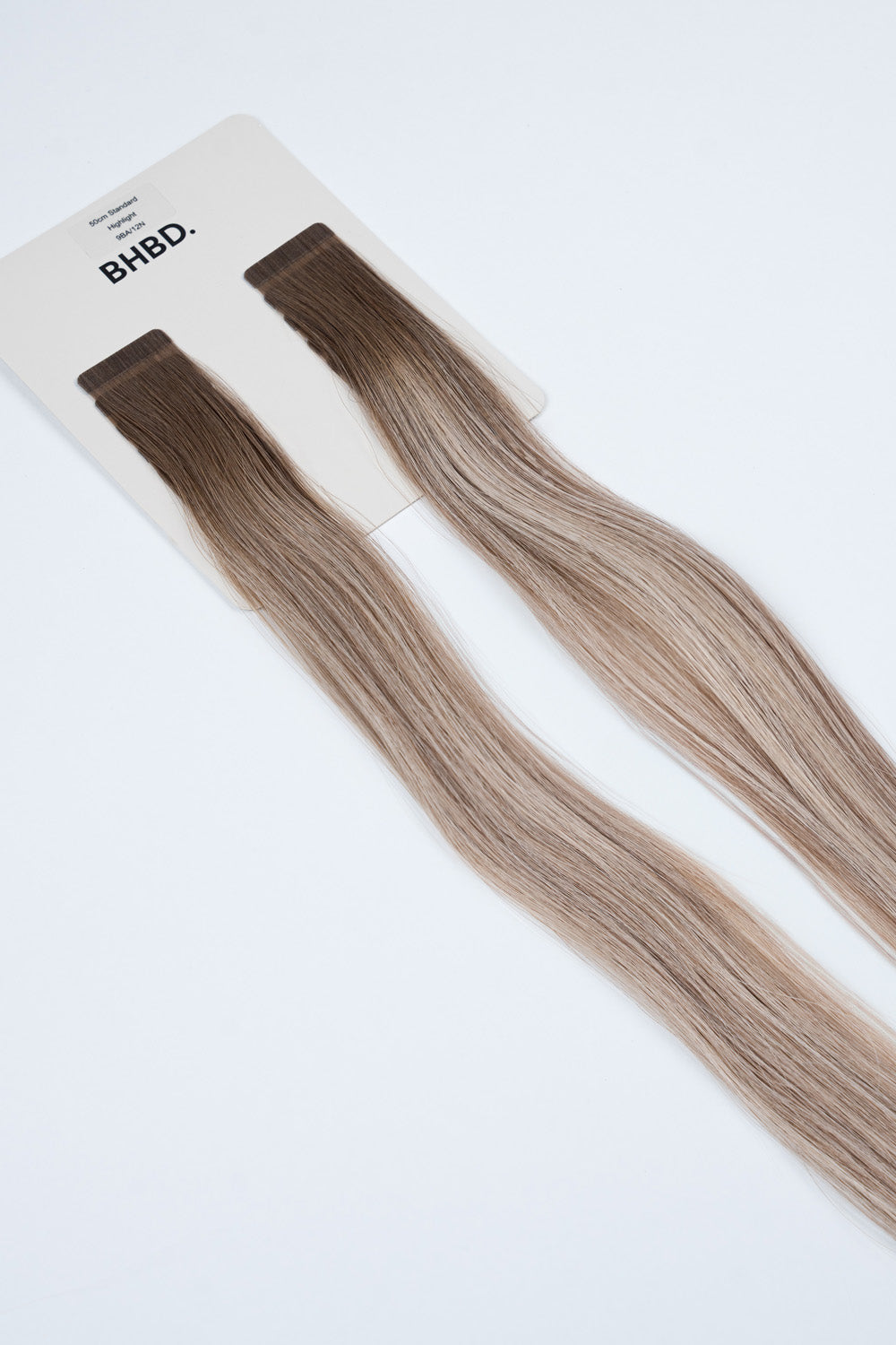 BHBD Tape Extensions 9BA/12N Highlight – pre-taped Remy human hair extensions in bright blonde with warm tones; seamless, soft and tangle-free; comes in 35cm, 50cm, and 60cm. 100% Remy hair, gentle extensions.