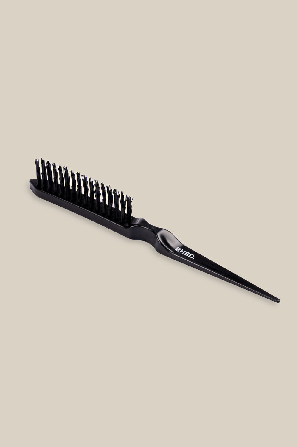 BHBD Remover Brush - Black hairbrush on a beige background - White BHBD Logo